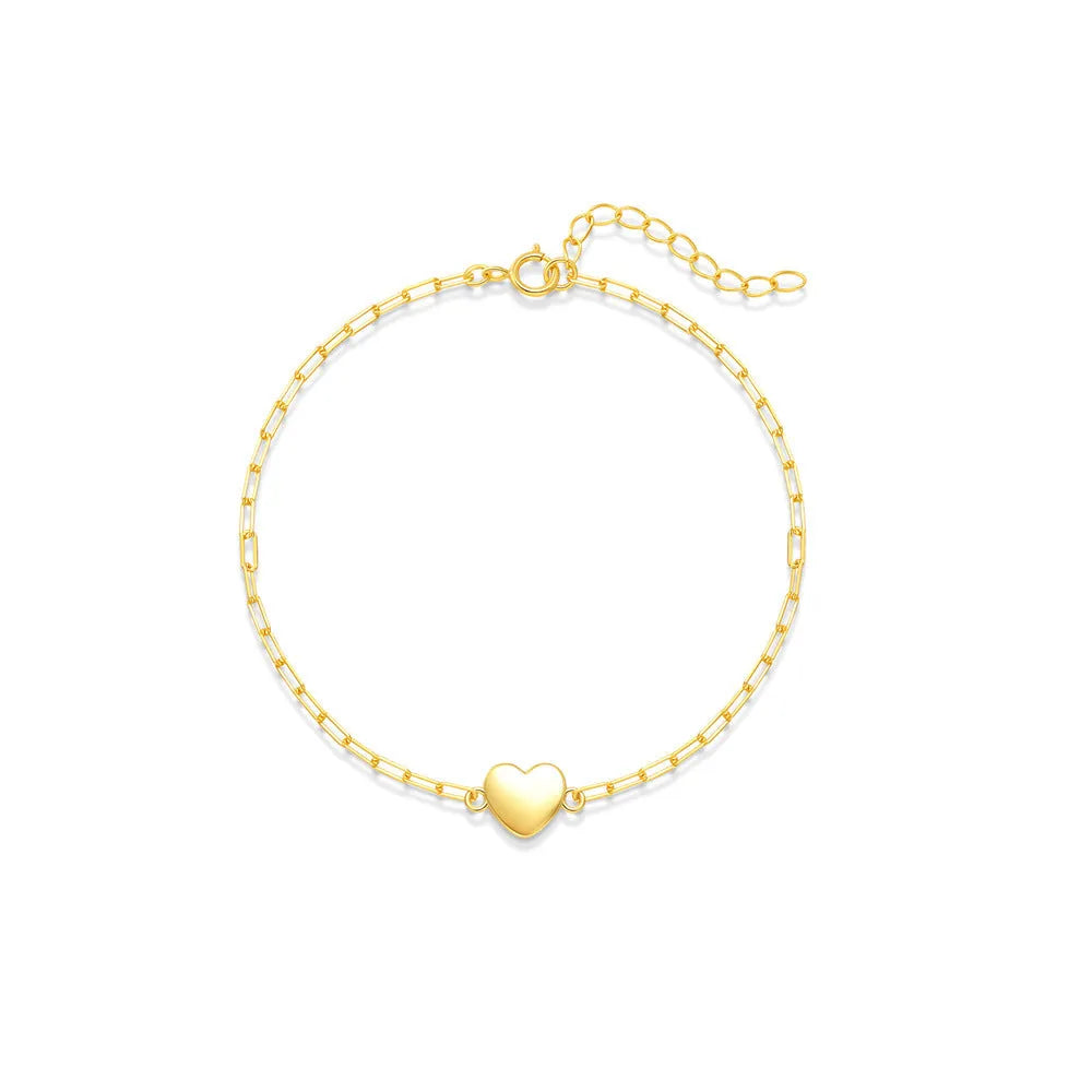 Close-up of a women's sterling silver bracelet with a glossy heart charm on an adjustable clip chain.