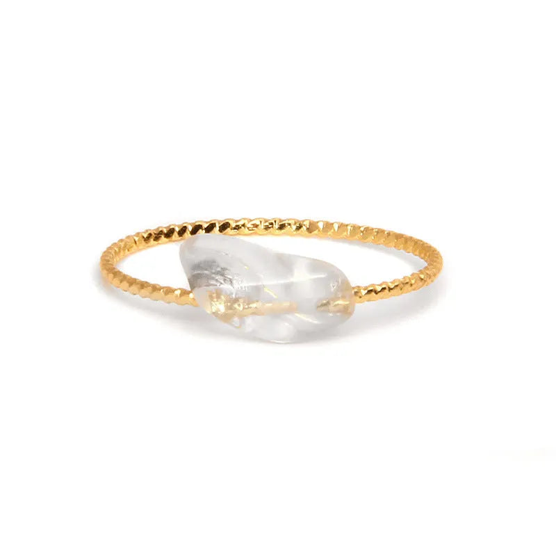 Geometric silver-tone ring with a coloured agate stone in a niche design, side view.