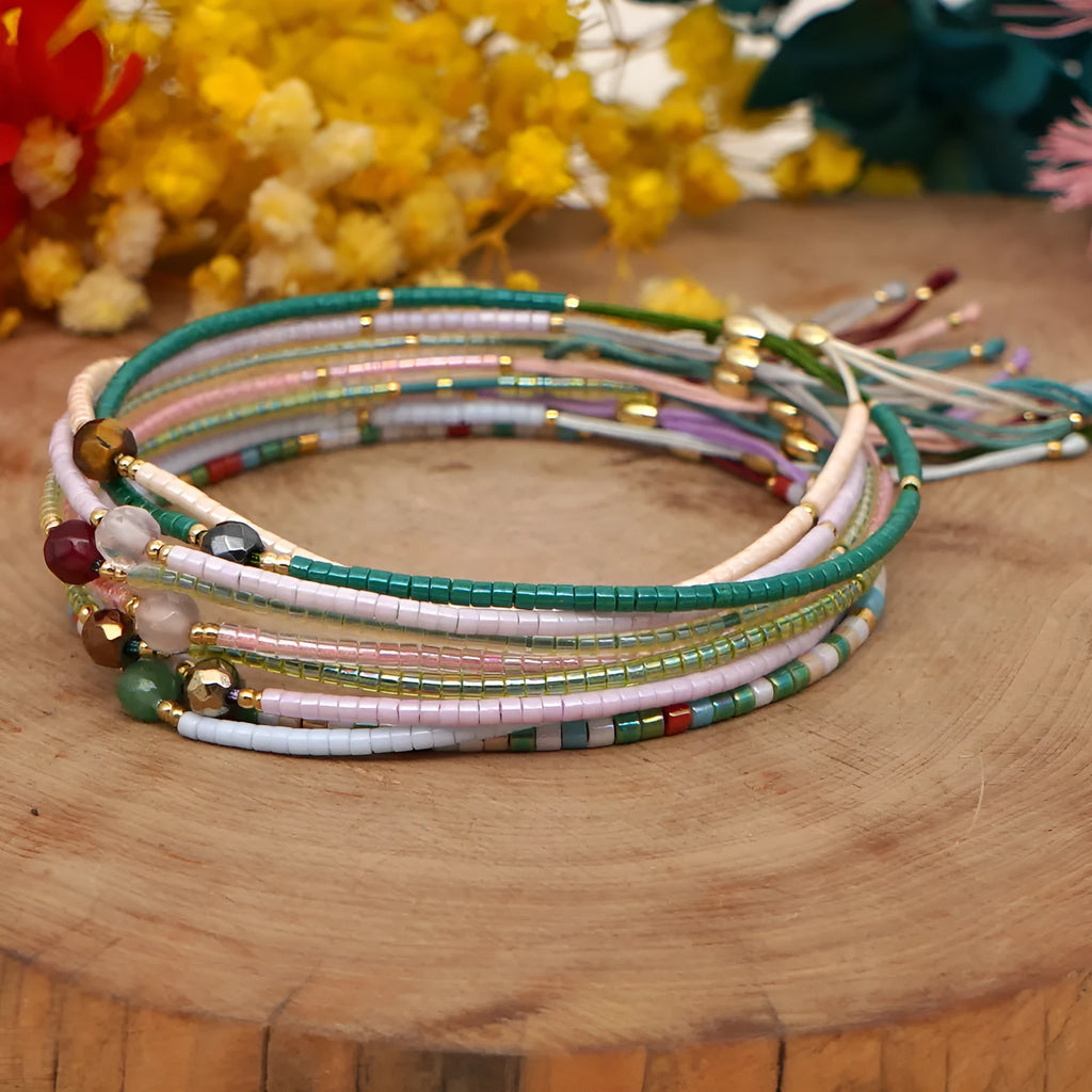 Close-up of a woman's handmade Bohemian bracelet with colourful geometric glass and glaze beads.