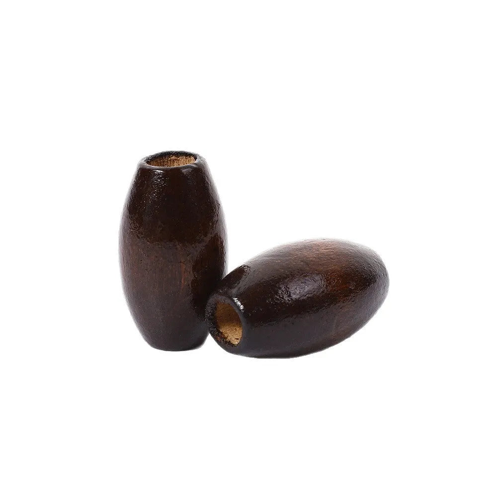 Dark coffee coloured wooden oval bead with M-shaped raised design, 25mm size