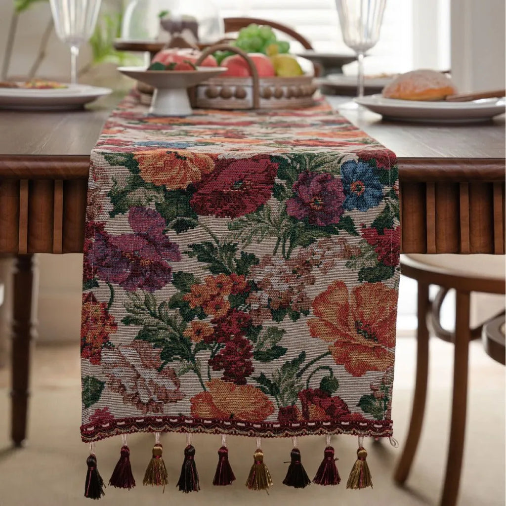 American-style beige jacquard table runner with long tassels and floral pattern on a dining table.