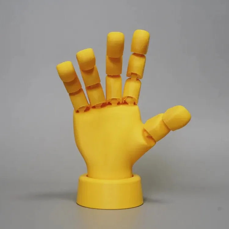 Yellow American-style hand prop figurine with movable joints on a white background