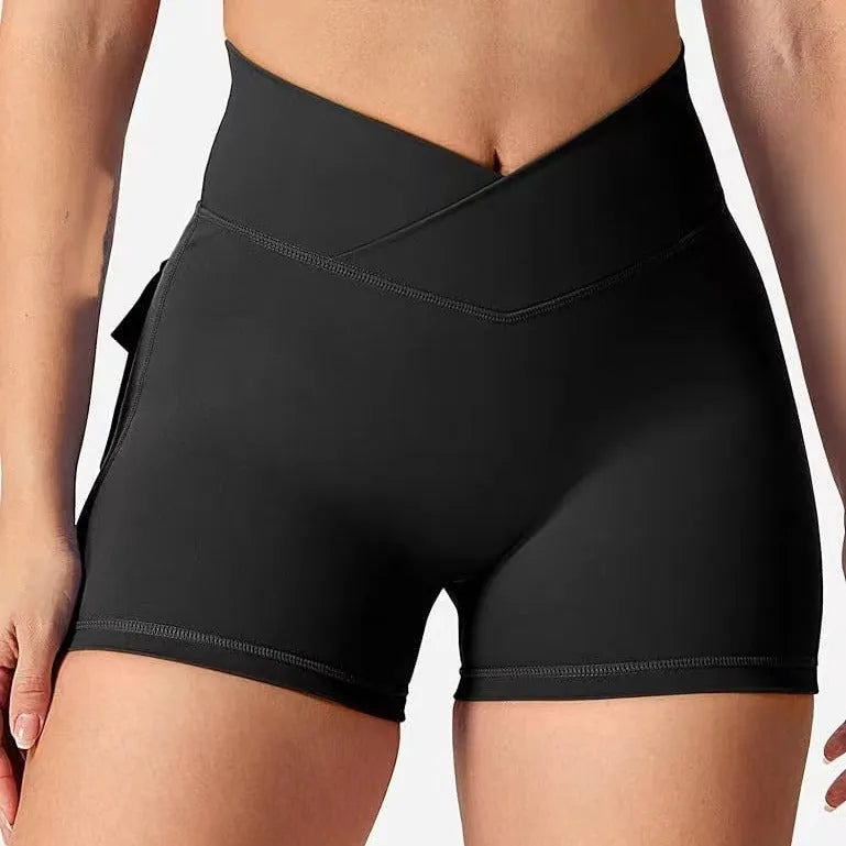 Women's peach hip-tight workout shorts in chemical fibre blend fabric for fitness activities