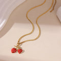 Stainless steel strawberry pendant necklace on an alloy chain, shown in red and white gradient colour options.