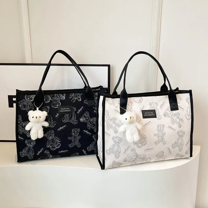 Women's black canvas tote bag with rhombus pattern and sandwich pocket compartments