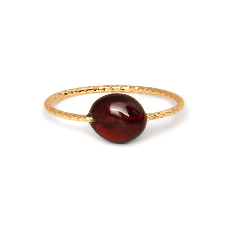 Geometric silver-tone ring with a coloured agate stone in a niche design, side view.