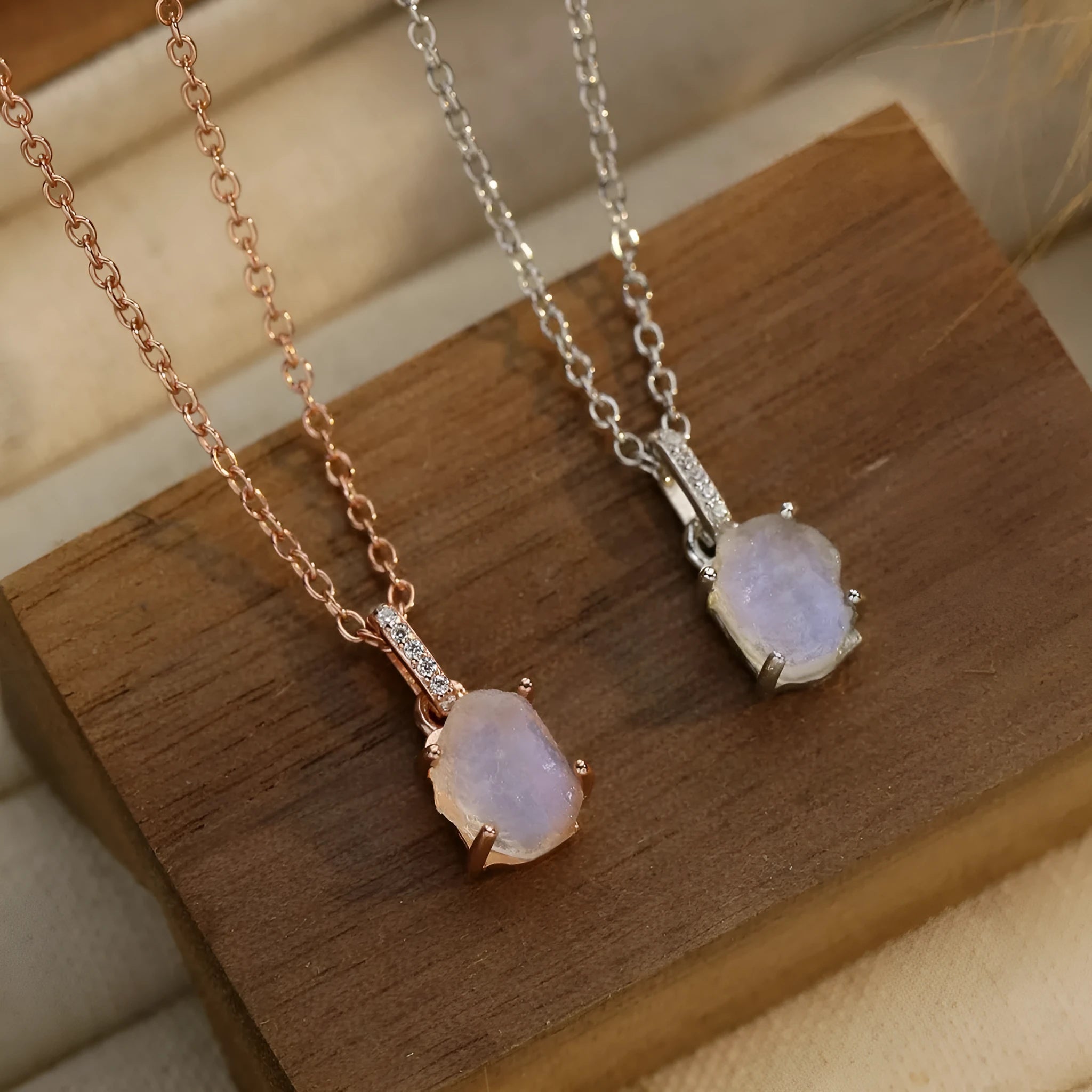 Geometrical quadrilateral moonstone pendant on an adjustable sterling silver curb chain necklace.