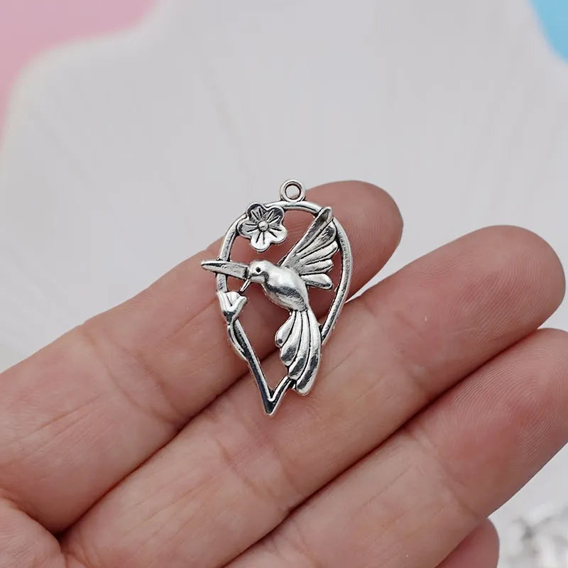 Close-up of a detailed alloy cuckoo bird charm pendant with electroplated finish in colour P234.