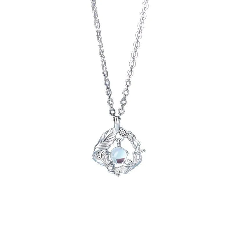 Geometric alloy pendant necklace featuring a tree and bird design on an adjustable chain.