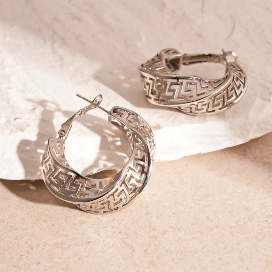 Geometric hollow stud earrings in gold and silver colours with twisted round design