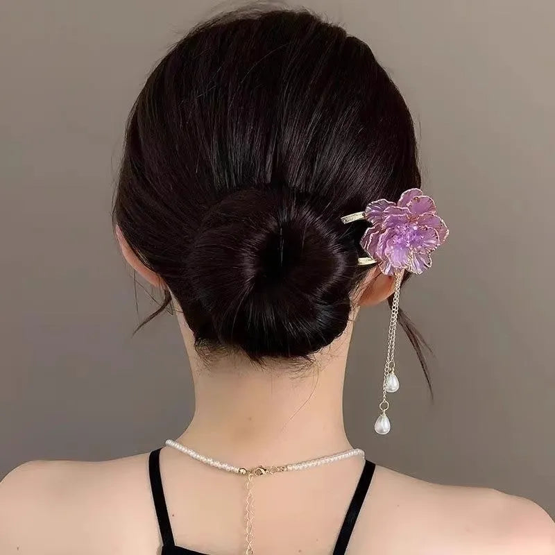 Close-up of a purple alloy U-shaped hairpin with a detailed peony flower and tassel design on a white background.