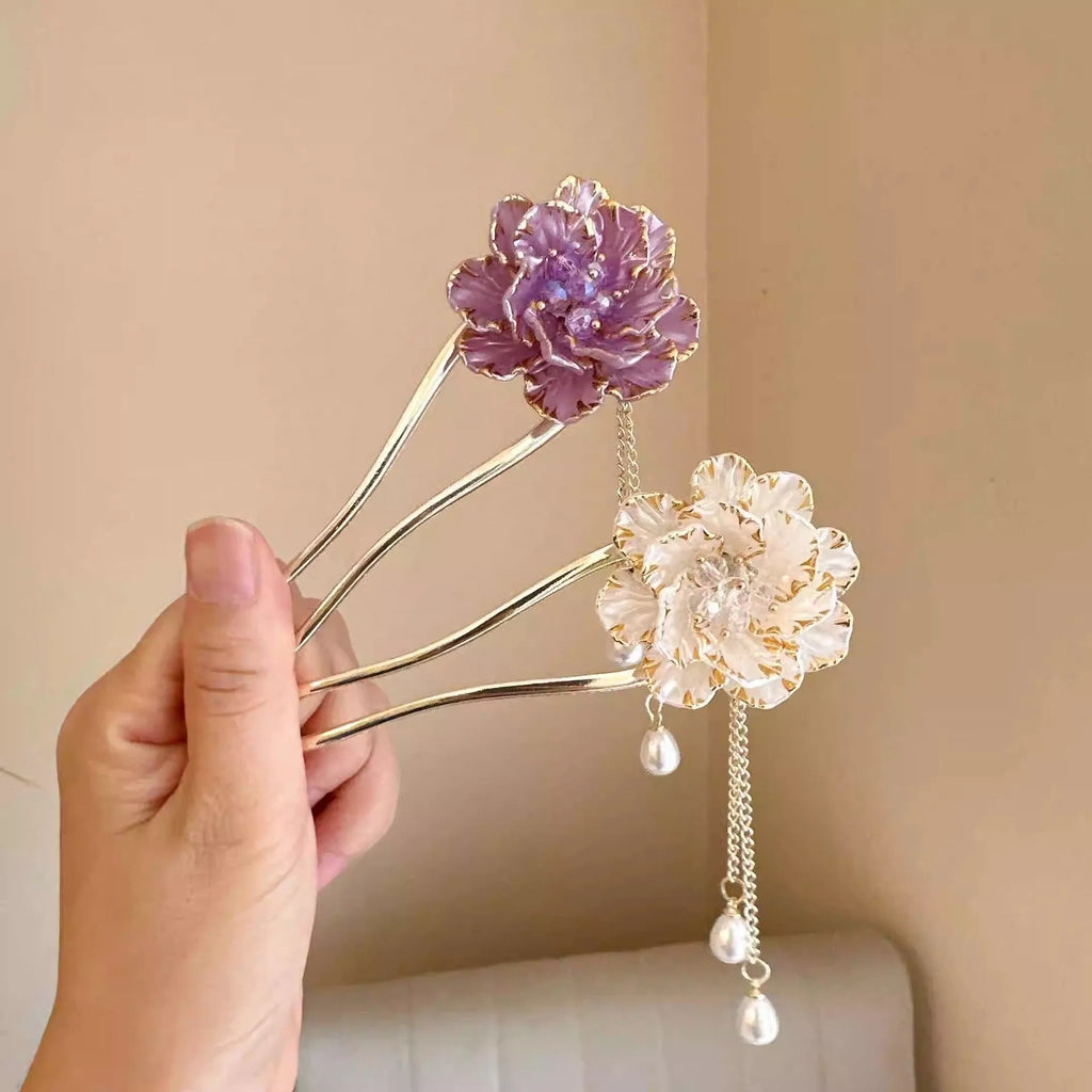 Close-up of a purple alloy U-shaped hairpin with a detailed peony flower and tassel design on a white background.