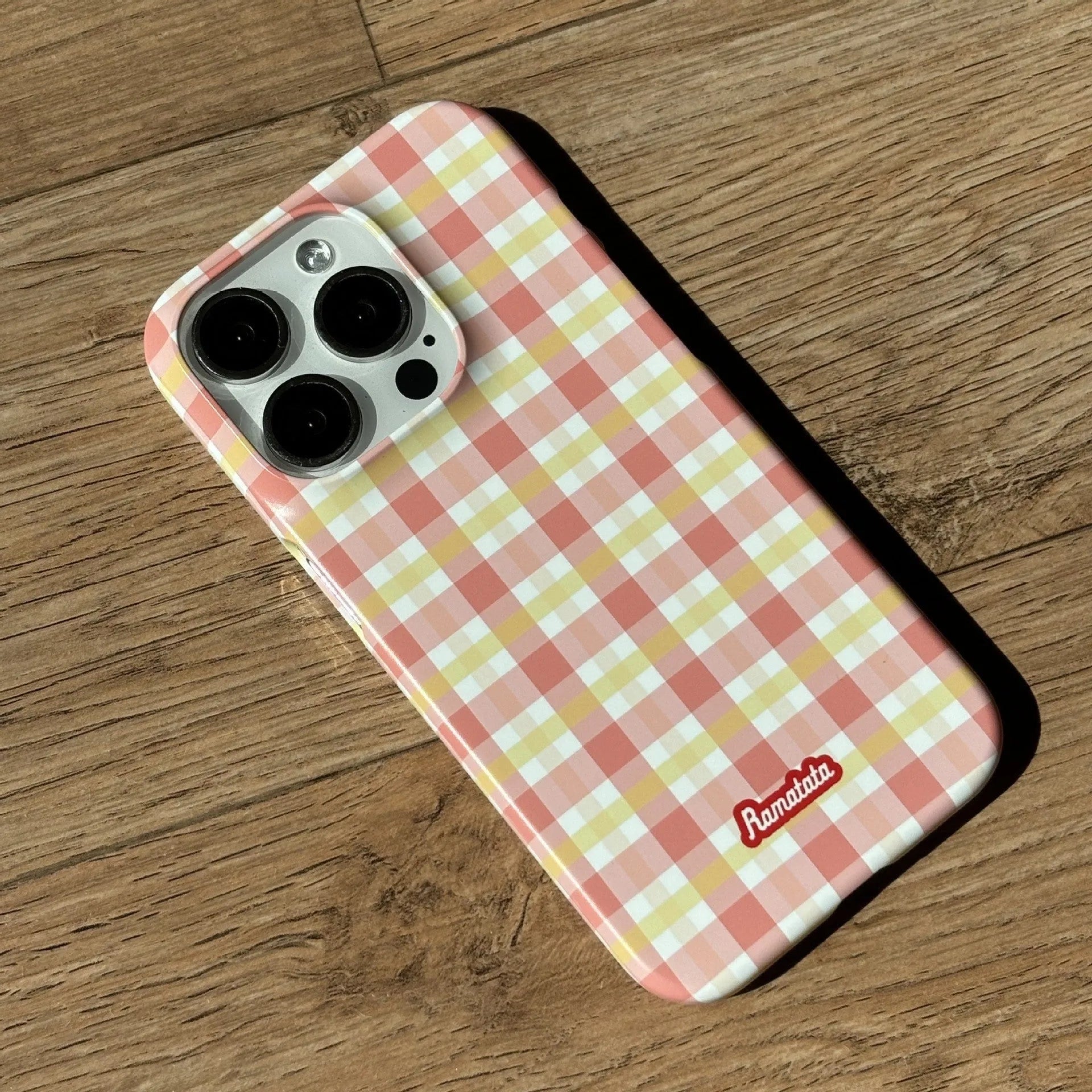 iPhone 15 Pro Max phone case with plaid design in red or orange grid pattern