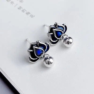 Blue lotus seedpod tassel ear studs with floral design on silver needle fittings