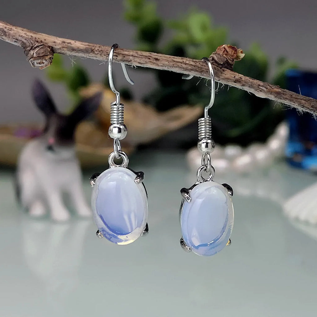 Women's opal earrings with cross pendant in drop shape and moonlight opal colour