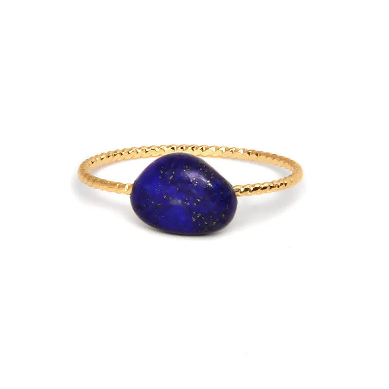 Geometric silver-tone ring with a coloured agate stone in a niche design, side view.