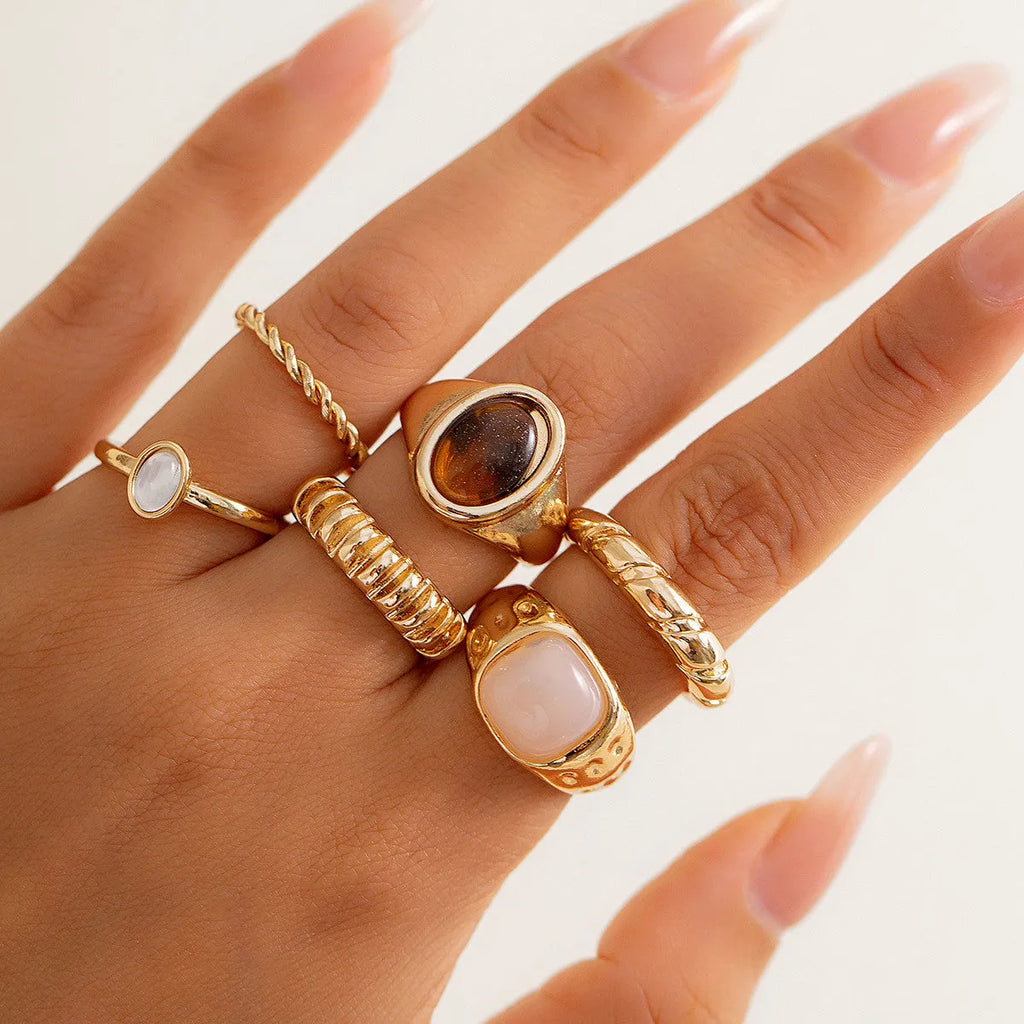 Set of six light gold geometric and round alloy rings with electroplated finish