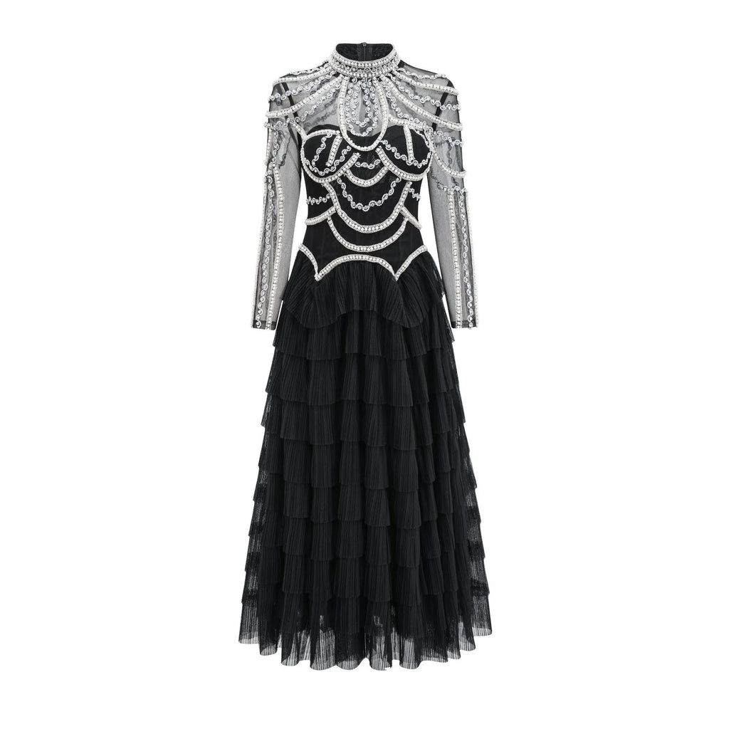 Women's black long sleeve beaded dress with mid waist and full-length skirt.