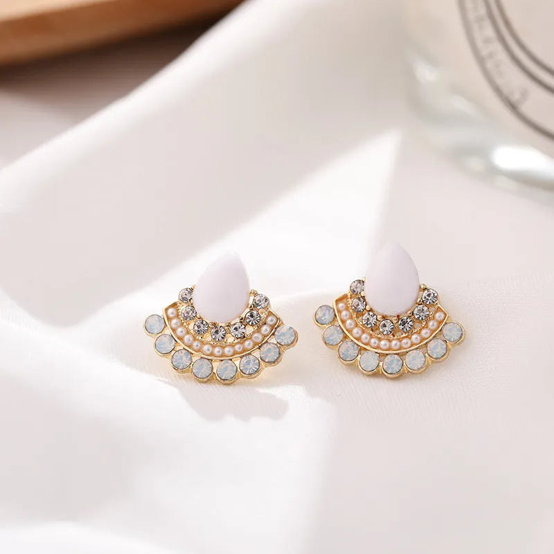 Women's silver retro fan-shaped earrings with an opal-like stone and rhinestone detailing on a geometric alloy setting.