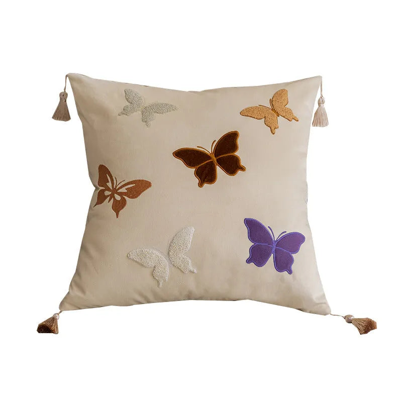 Square beige cushion with embroidered Chinese-style butterfly design.