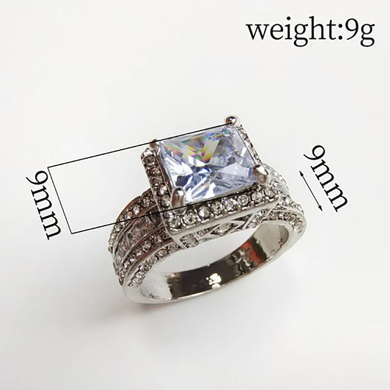 Geometric silver-toned women's ring with a round design element on a hand.