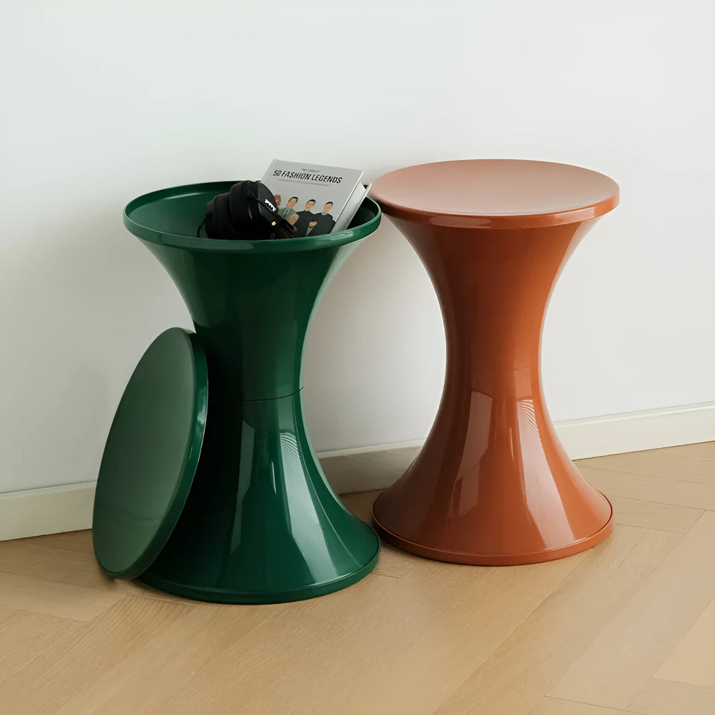 A white hourglass-shaped plastic shoe changing stool on a wooden floor.