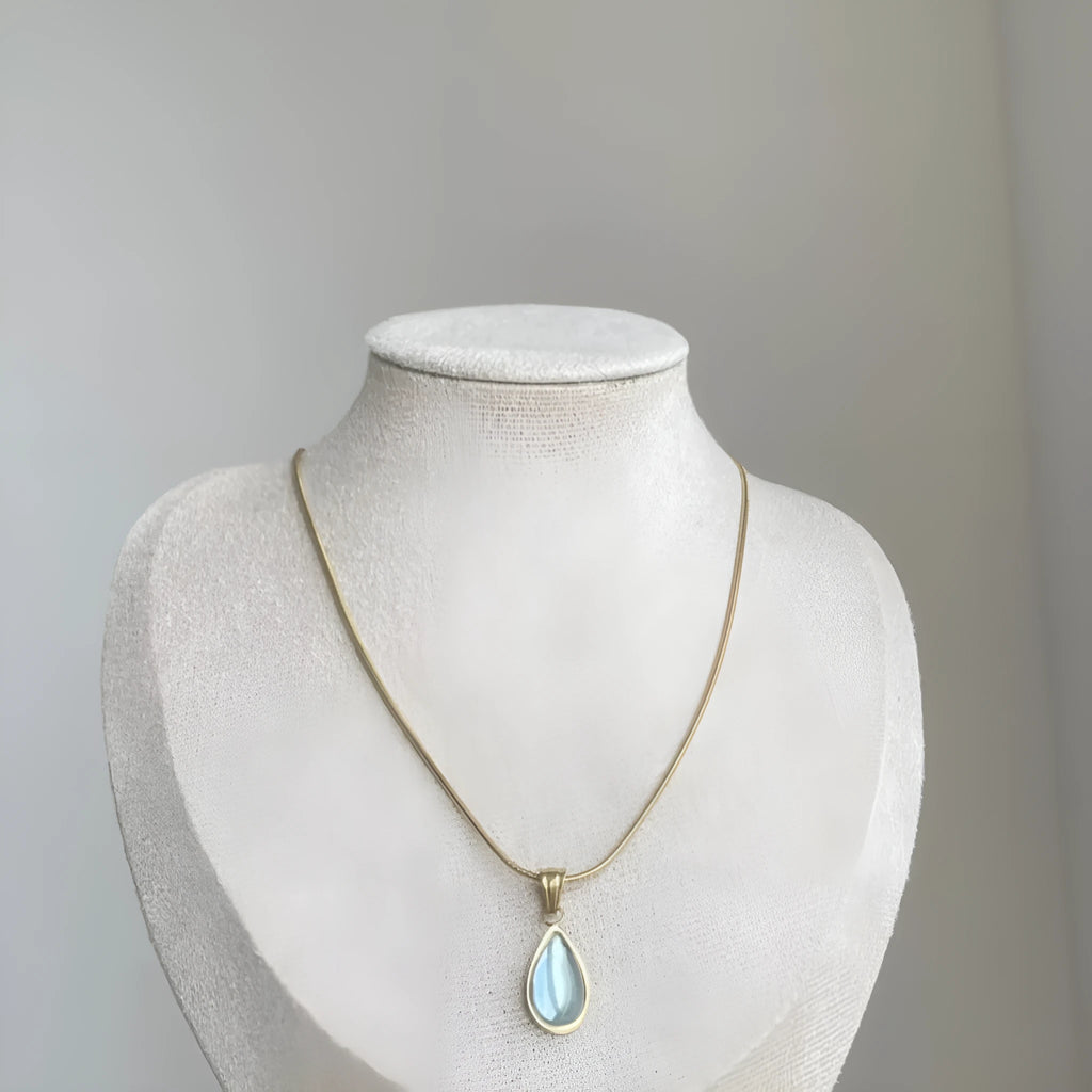 Retro water drop necklace for women with blue gemstone pendant on titanium steel snake bone chain.