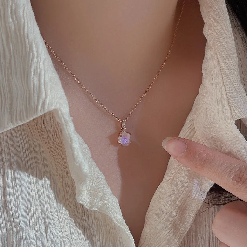 Geometrical quadrilateral moonstone pendant on an adjustable sterling silver curb chain necklace.