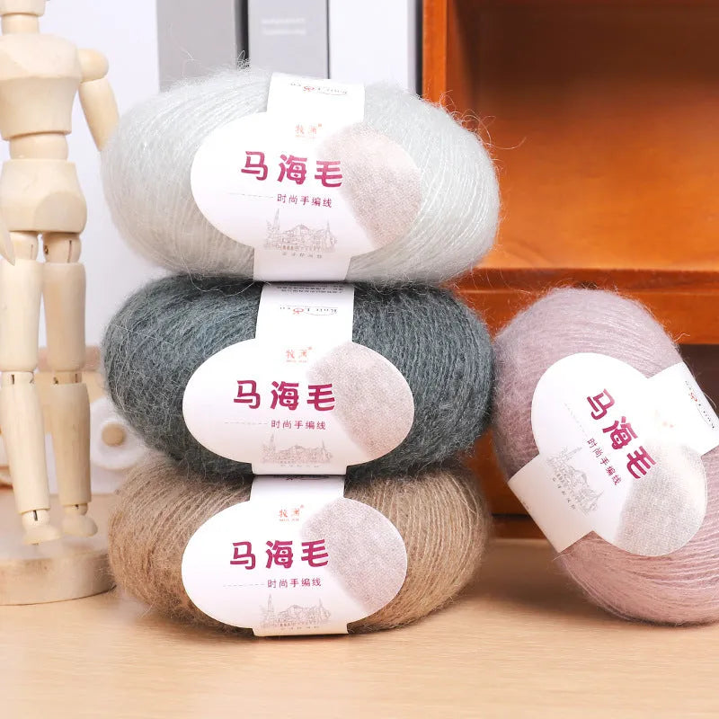 DIY mohair scarf knitting kit showing a ball of wool with 34 colour options including white, grey, pink, and blue.