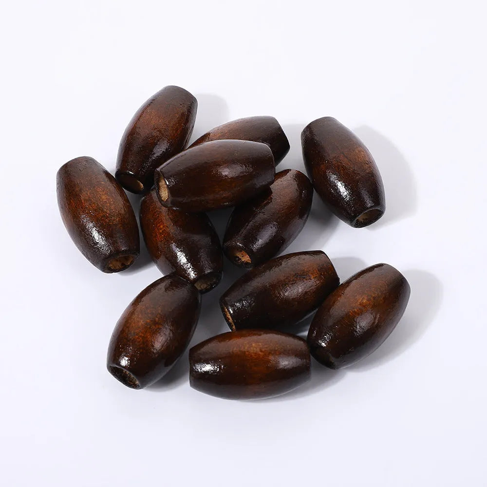 Dark coffee coloured wooden oval bead with M-shaped raised design, 25mm size
