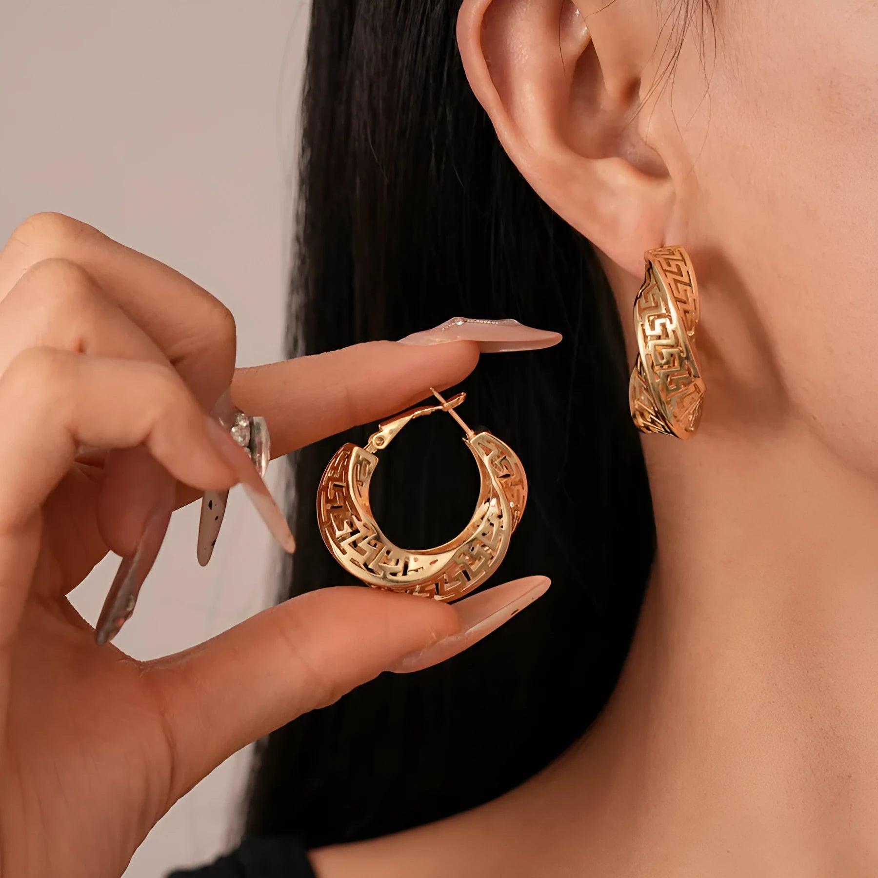 Geometric hollow stud earrings in gold and silver colours with twisted round design