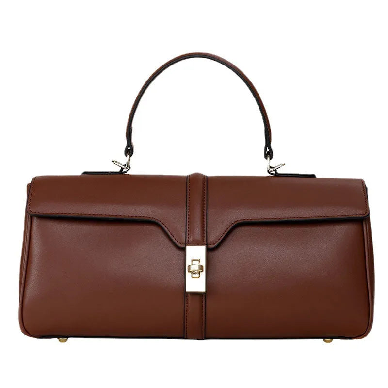 Women's cylindrical leather messenger bag in black with internal organiser pockets