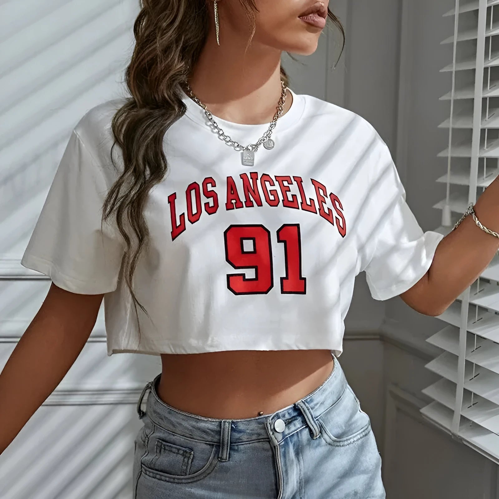 A black loose-fit women's cotton t-shirt with personalised white English letters printing on the front.