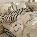 Cartoon dog pattern pure cotton four-piece bedding set shown on a bed, includes multiple size options.
