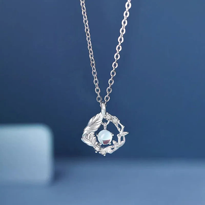 Geometric alloy pendant necklace featuring a tree and bird design on an adjustable chain.