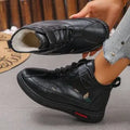 Women's black velvet slipper with low-cut design, hollow-out detail, and a light-coloured non-slip rubber sole.