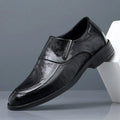 Men's black cowhide leather slip-on casual shoes with rubber sole on a plain background
