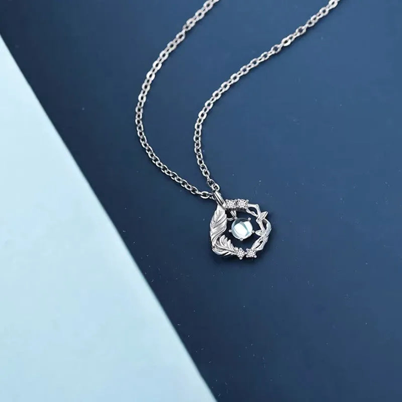 Geometric alloy pendant necklace featuring a tree and bird design on an adjustable chain.