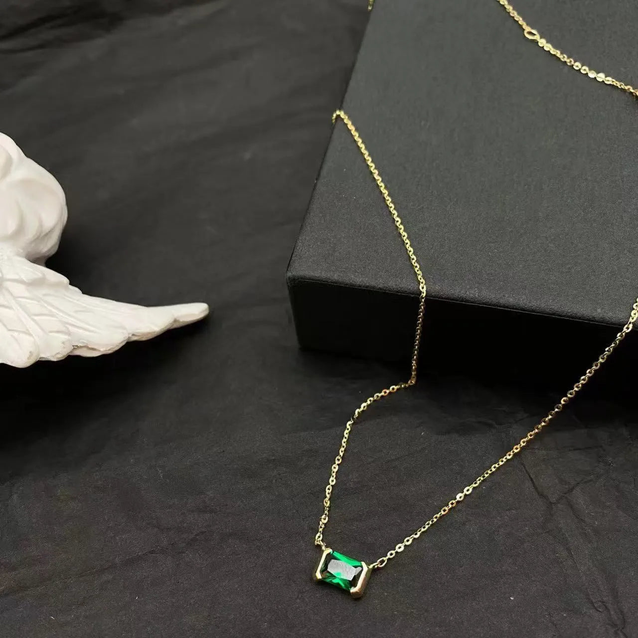 Gold geometric pendant necklace with a square Lvzuan stone inlay on a chain