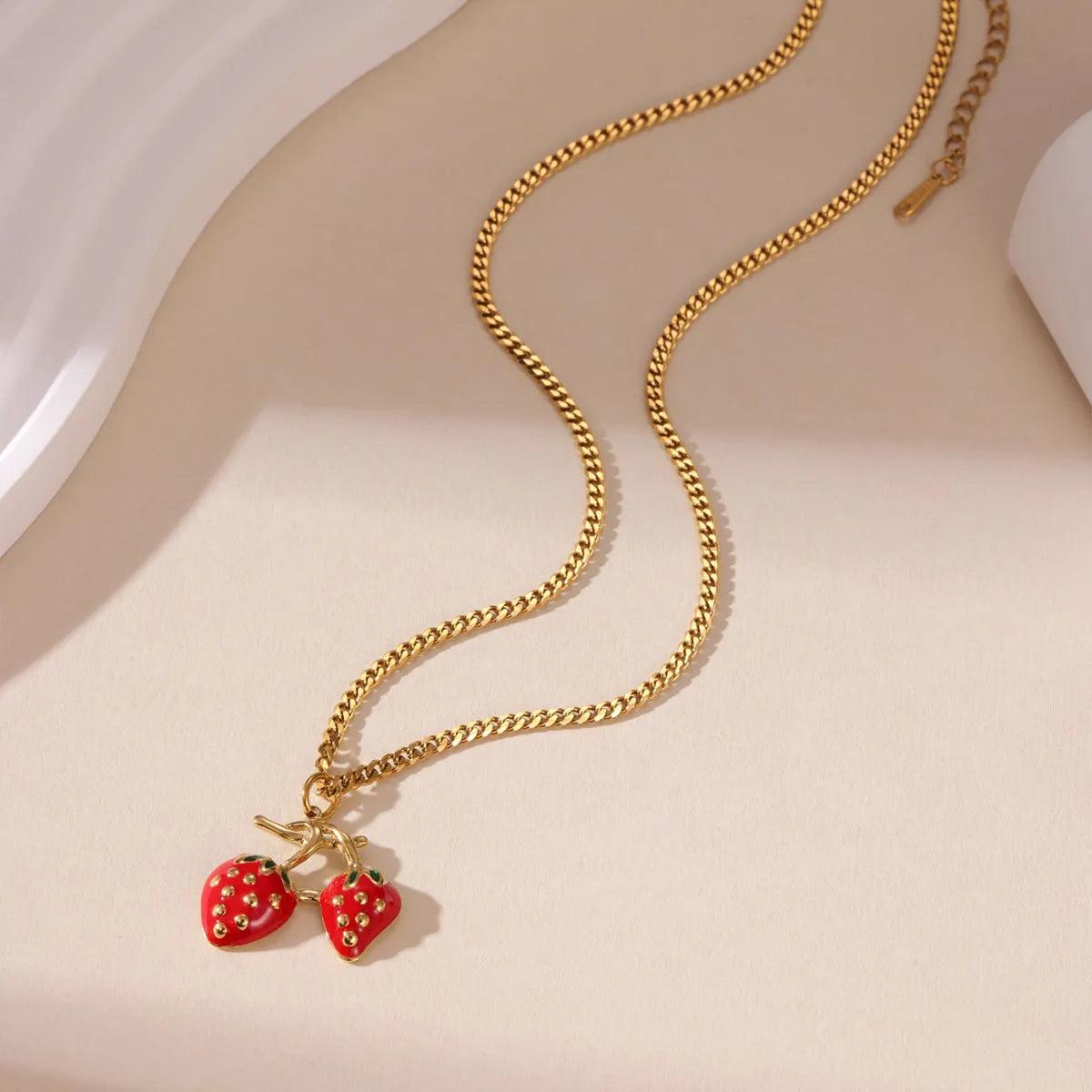 Stainless steel strawberry pendant necklace on an alloy chain, shown in red and white gradient colour options.