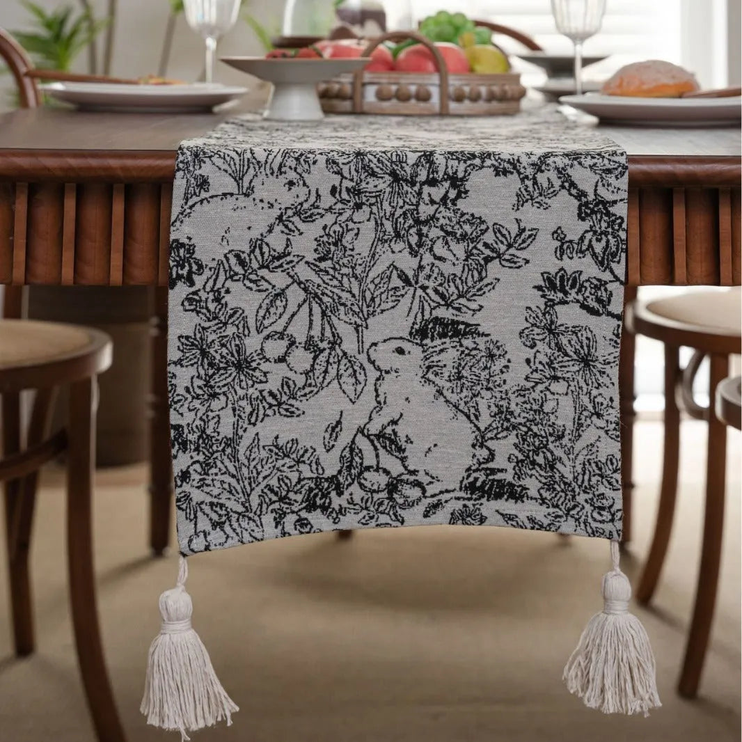American-style beige jacquard table runner with long tassels and floral pattern on a dining table.