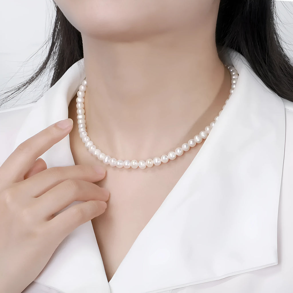 Women's silver necklace with round natural freshwater pearls on an adjustable chain.