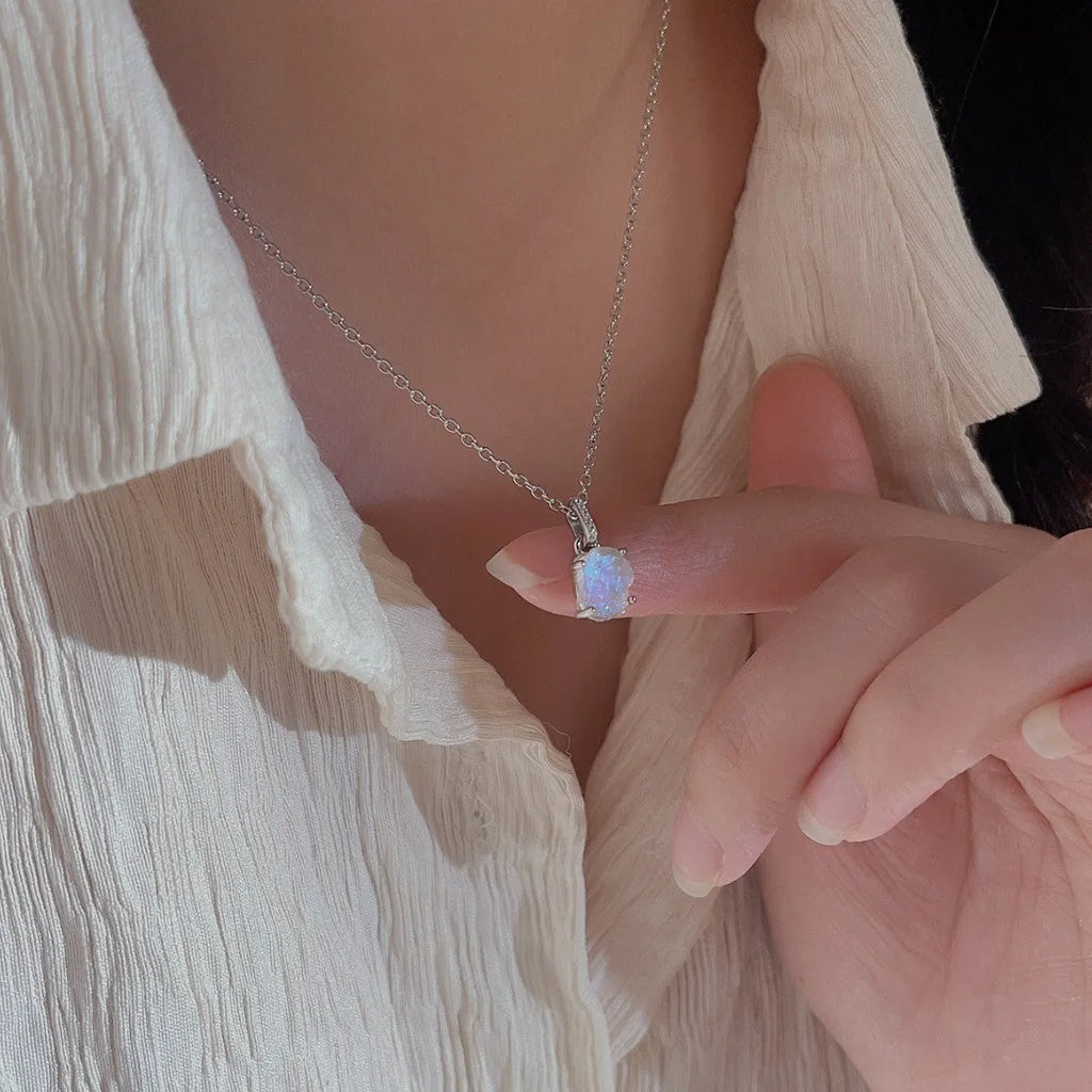 Geometrical quadrilateral moonstone pendant on an adjustable sterling silver curb chain necklace.