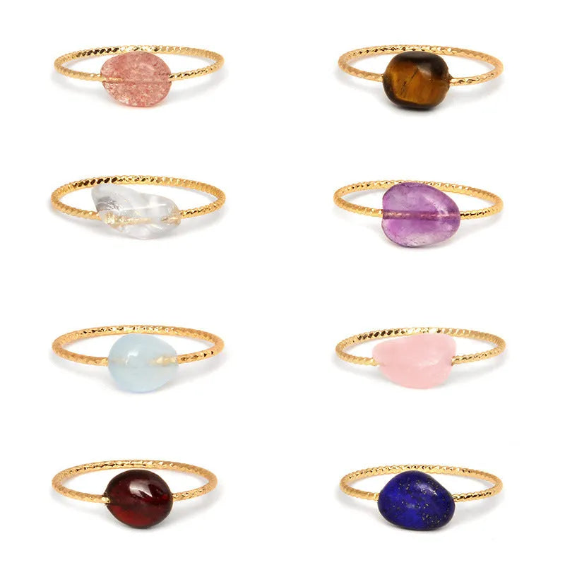 Geometric silver-tone ring with a coloured agate stone in a niche design, side view.