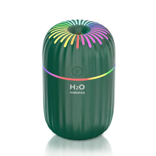 Mini animal-shaped USB humidifier and aromatherapy diffuser in green on a car dashboard.