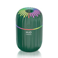 Mini animal-shaped USB humidifier and aromatherapy diffuser in green on a car dashboard.