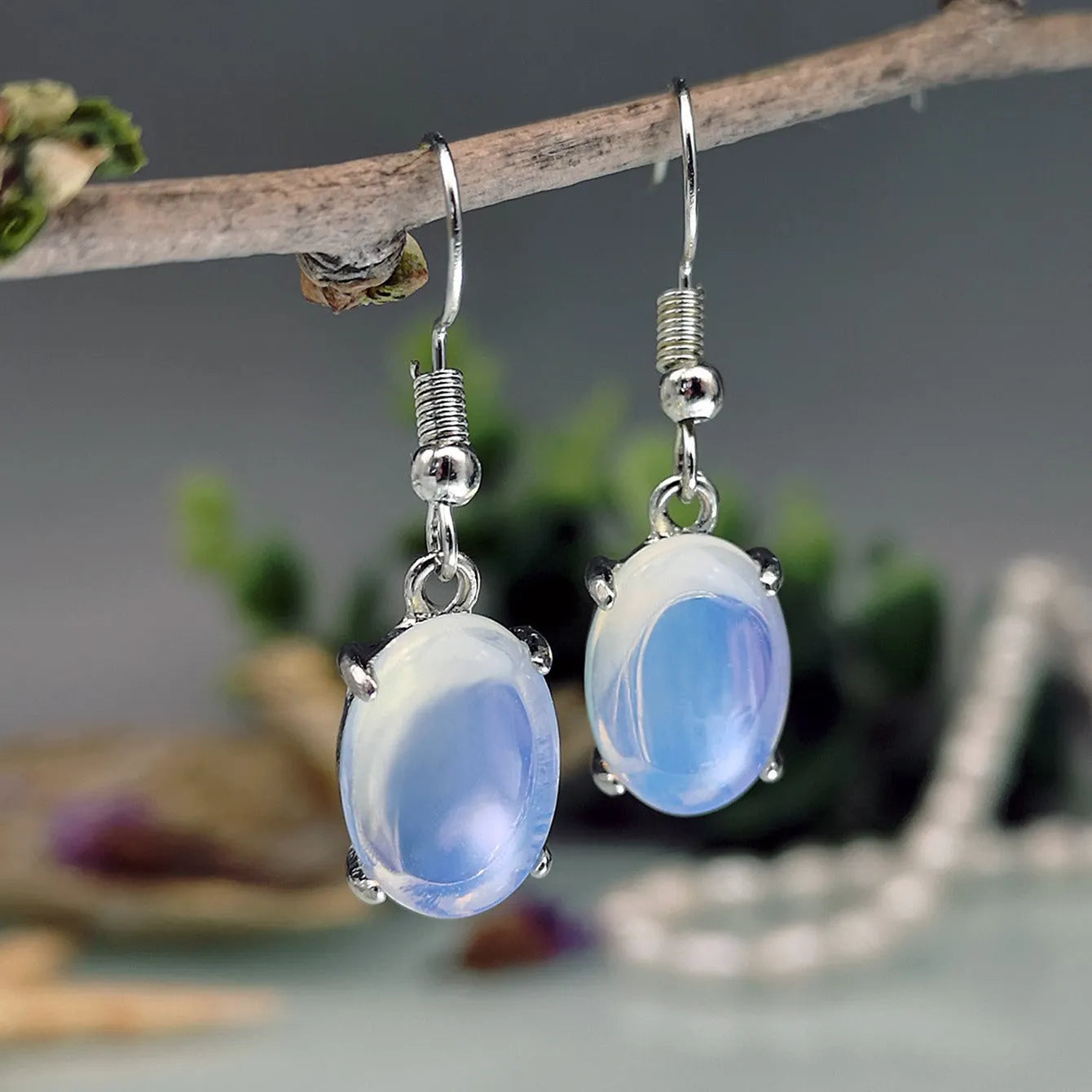 Women's opal earrings with cross pendant in drop shape and moonlight opal colour
