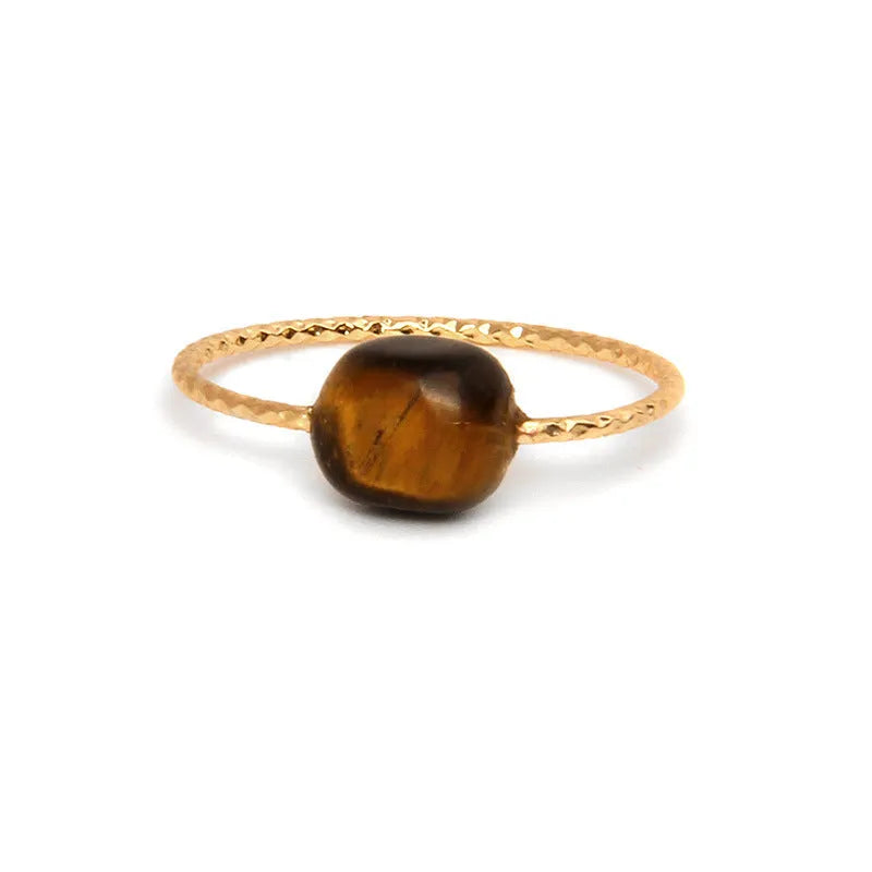 Geometric silver-tone ring with a coloured agate stone in a niche design, side view.