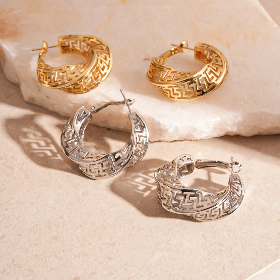 Geometric hollow stud earrings in gold and silver colours with twisted round design