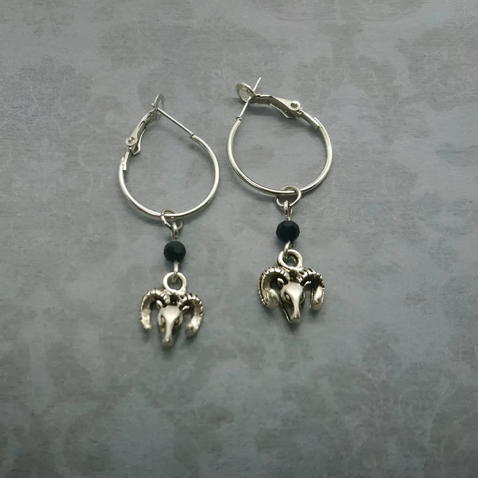 Silver round ring earrings for women with Tibetan antelope style design.